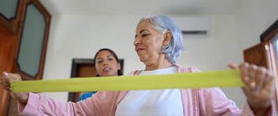 Woman exercising with caregiver