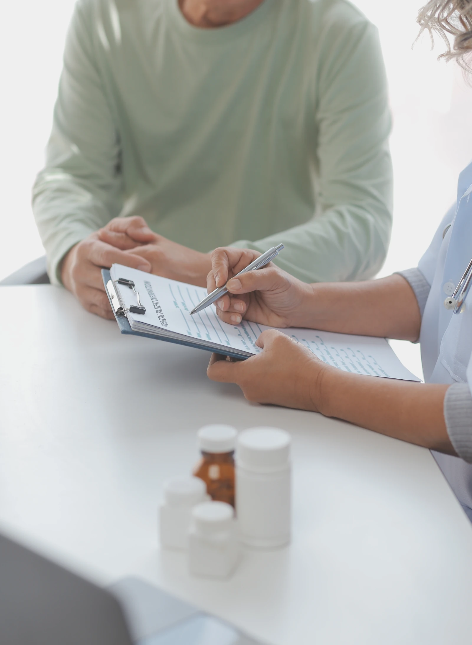 Patient reviewing a research form with a healthcare provider