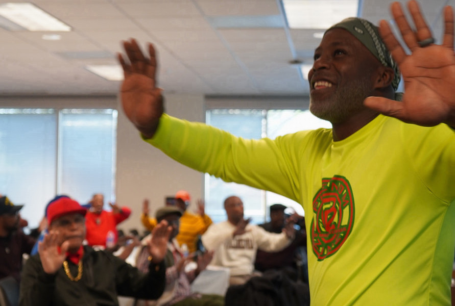 Men raising their hands with joy