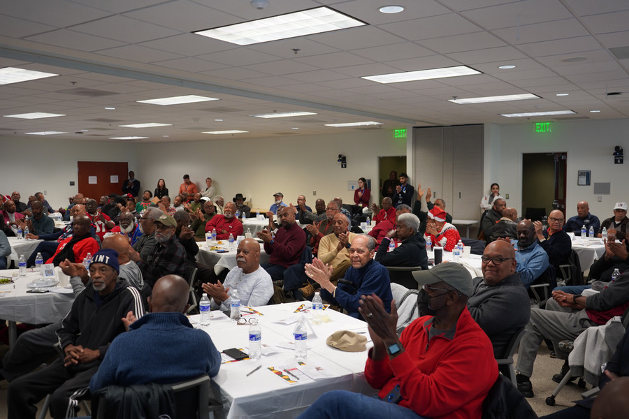 Attendees applaud during program