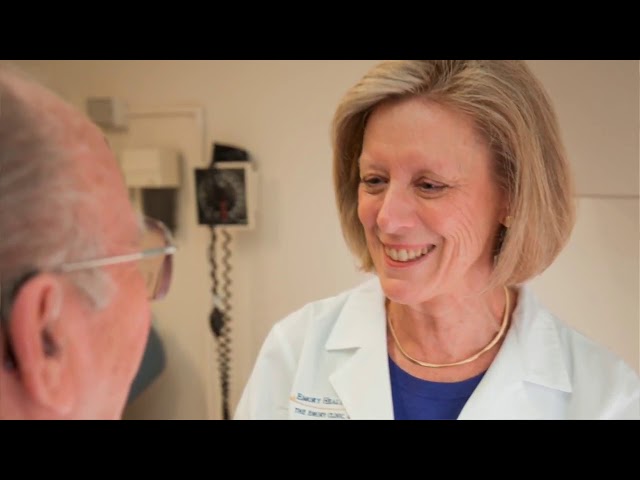 Female doctor smiling at an older male patient